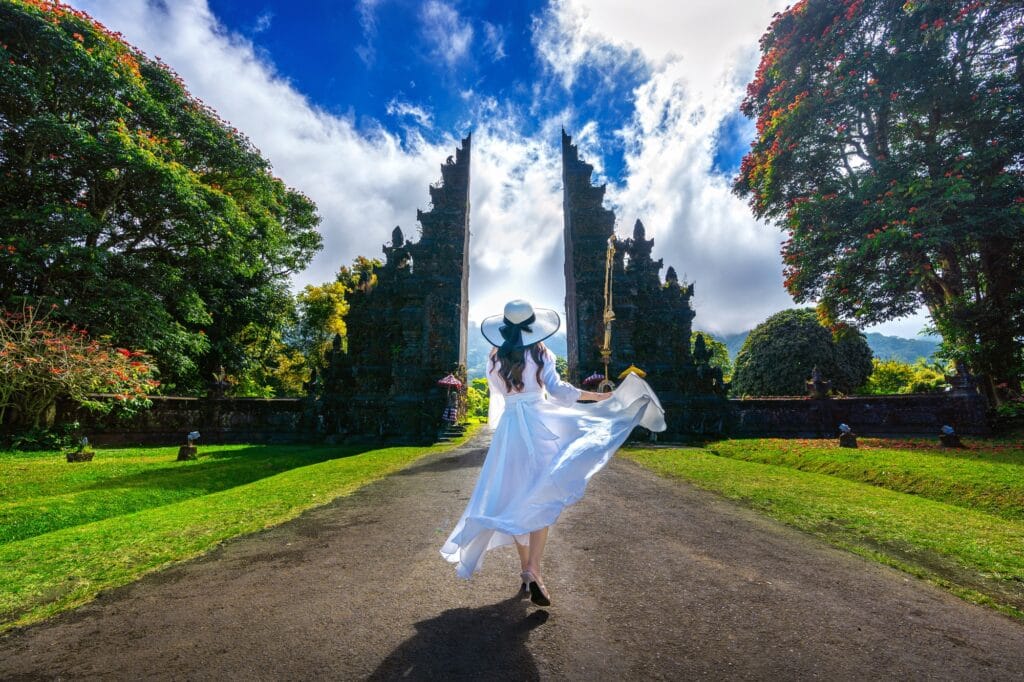 woman-walking-big-entrance-gate-bali-indonesia